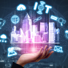 Hand holding an image of a city with icons representing different technologies floating above.