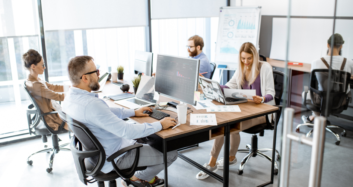 Two men and a woman working on computers.